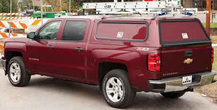 Leer truck cap on a red pickup