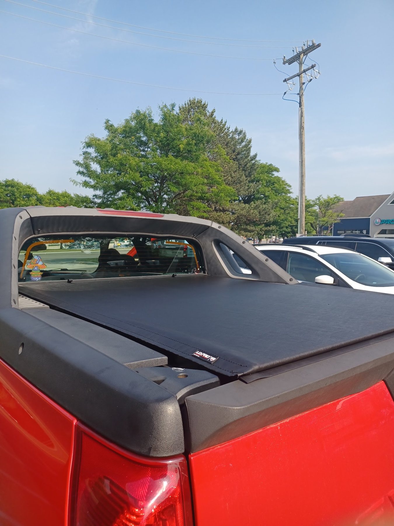 Tonneau cover installed on a red truck